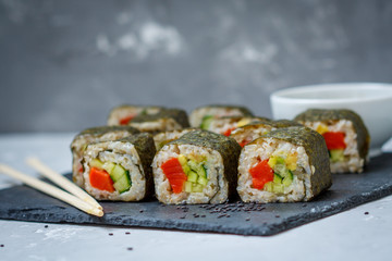 Healthy homemade sushi rolls with brown rice and fish.