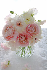 Bouquet of beautiful ranunculus flowers in vase on white background
