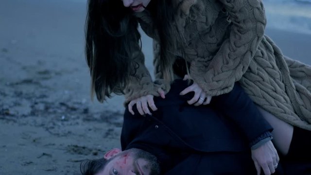 Female vampire screaming after killing man