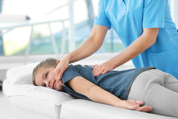 Physiotherapist working with patient in clinic