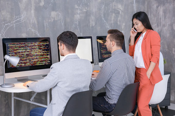 Obraz premium Young programmers working in office