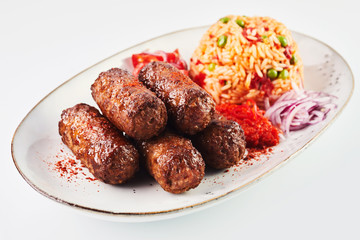 Fried cevapcici seasoned with paprika