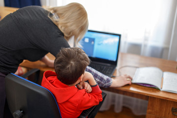 Mother turning off computer for computer addicted little kid
