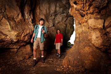 Young Couple Exploring A Cave