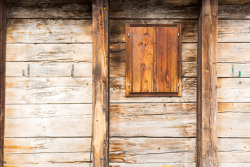 Wall of rough wood planks in horizontal with window on the right