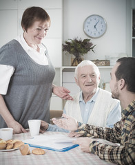 Elderly couple and social employee