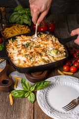 Baked pasta with broccoli, cauliflower, cheese and bechamel sauc