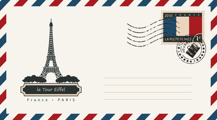 an envelope with a postage stamp with the Eiffel tower in Paris, and the flag of France