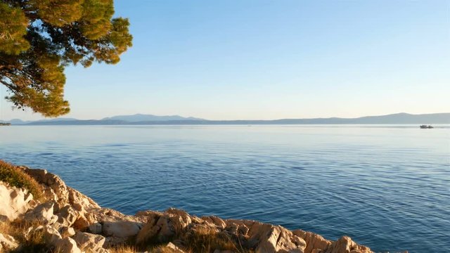 Calm blue sea on sunny day and scenic coastline landscape