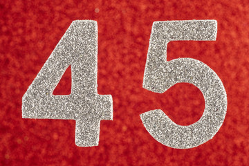 Number forty-five silver color over a red background. Anniversary.
