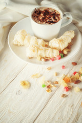 Cup of hot cocoa and cream cakes