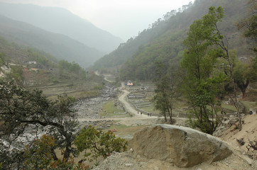 A winding road passes between the mountains in the valley of Nepal