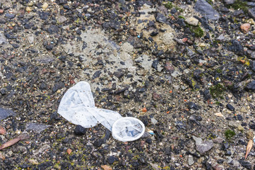 White used condom on the ground