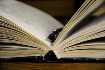 Open book and fountain pen