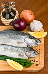 close-up raw fish trout on a wooden board