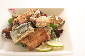 Japanese food, deep fried Sanma Pacific saury served with baby life and lemon