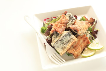 Japanese food, deep fried Sanma Pacific saury served with baby life and lemon