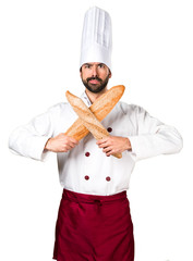 Young baker holding some bread making NO gesture