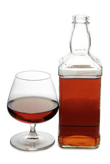 Glass with brandy and whiskey on white background