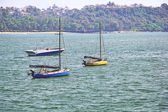 Morning scene of three boats anchored in outer sea in Dona Paula in Goa, India