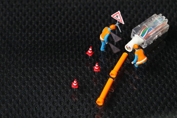 The damaged lan connection cable plug and maintenance figure miniature model represent the computor business and technology concept related idea. 