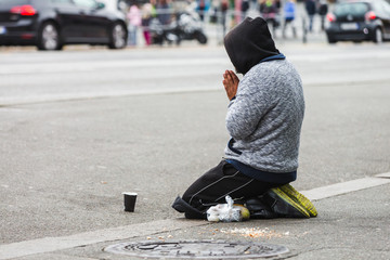 A beggar on the street, praying man
