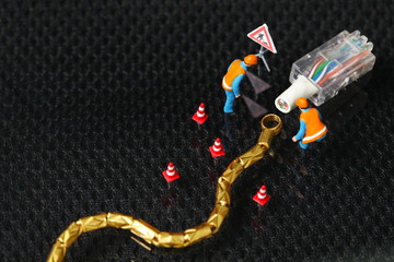 The damaged lan connection cable plug and maintenance figure miniature model represent the computor business and technology concept related idea. 