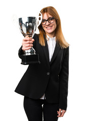 Young business woman holding a trophy