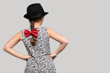 Girl with red bow and black hat