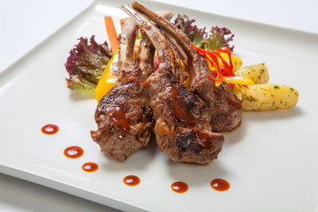 Pork ribs grilled with roasted vegetables and boiled potatoes