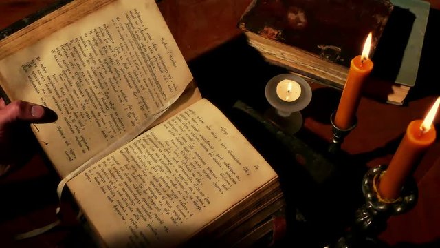 Reading Old Book Under Candlelight