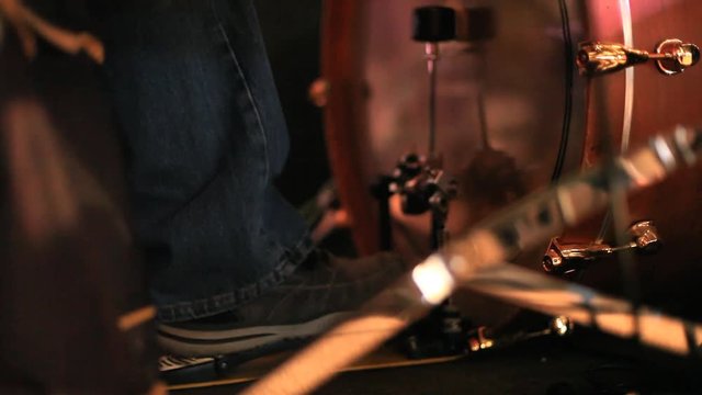 A drummer playing the bass drum with his foot