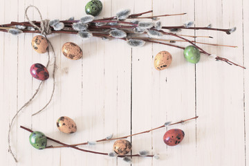 Easter eggs and willow branches on a white background