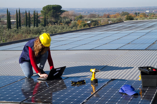 young skilled girl fitting a photovoltaic plant