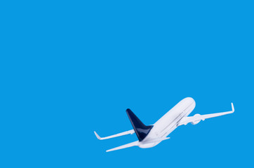 Model of passenger plane on blue background