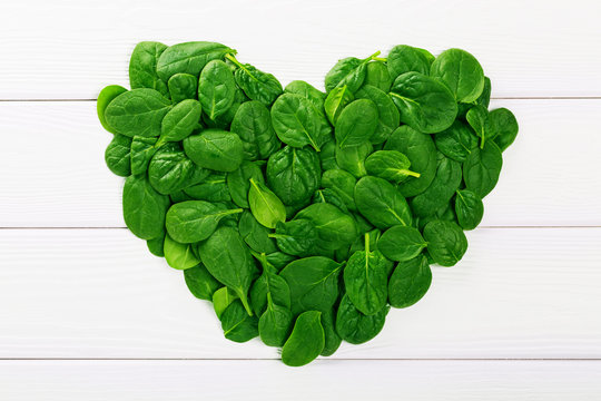Heartshaped sign made of fresh green spinach leaves