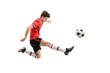 Tuinposter Teenage soccer player kicking a football © Ljupco Smokovski