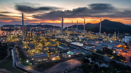 Fototapeta na wymiar Aerial view Oil refinery with a background of mountains and sky.The factory is located in the middle of nature and no emissions. The area around the air pure.