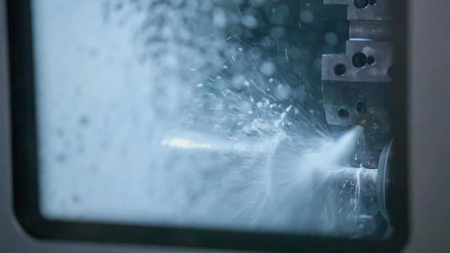 We can see that there is a lot of water coming out from the machine. A drill is also shaping an item.
