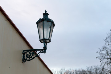Fototapeta na wymiar street gas lamp on the wall of the old city street lights in the past
