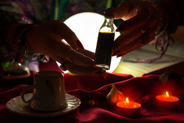 Hands of an fortune-teller holding love potion