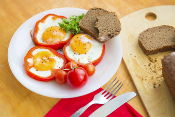 Fried eggs in red peppers