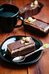 Delicious chocolate cake on plate on table on wooden background