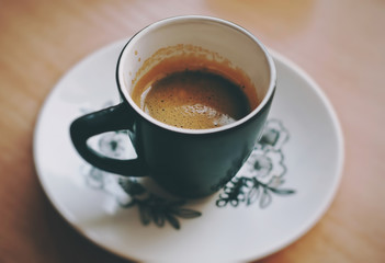 Cup of fresh morning espresso coffee with a beautiful thick tiger crema, close up view