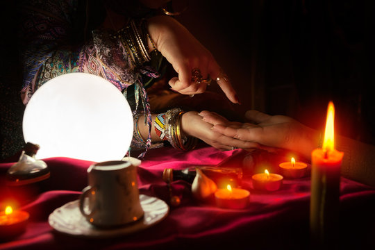 Fortune teller woman reading the future in a hand