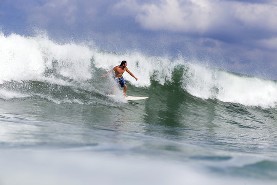 Indonesia, Bali, man surfing on a wave
