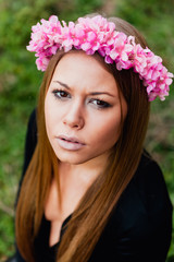Naklejka premium Beautiful portrait of a blonde girl with a pink crown of flowers