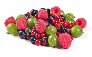 Heap of various kinds of fresh berries on a white