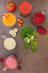 Colorful smoothies with various ingredients. Top view, blank space, rustic surface