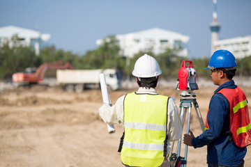 Construction engineer holding drawing and smart tablet with foreman worker checking construction site for new Infrastructure construction project.photo concept for engineering work